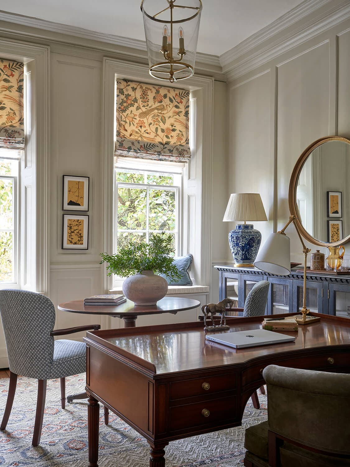 The second study, with painted panelling and a pair of armchairs beneath framed pictures